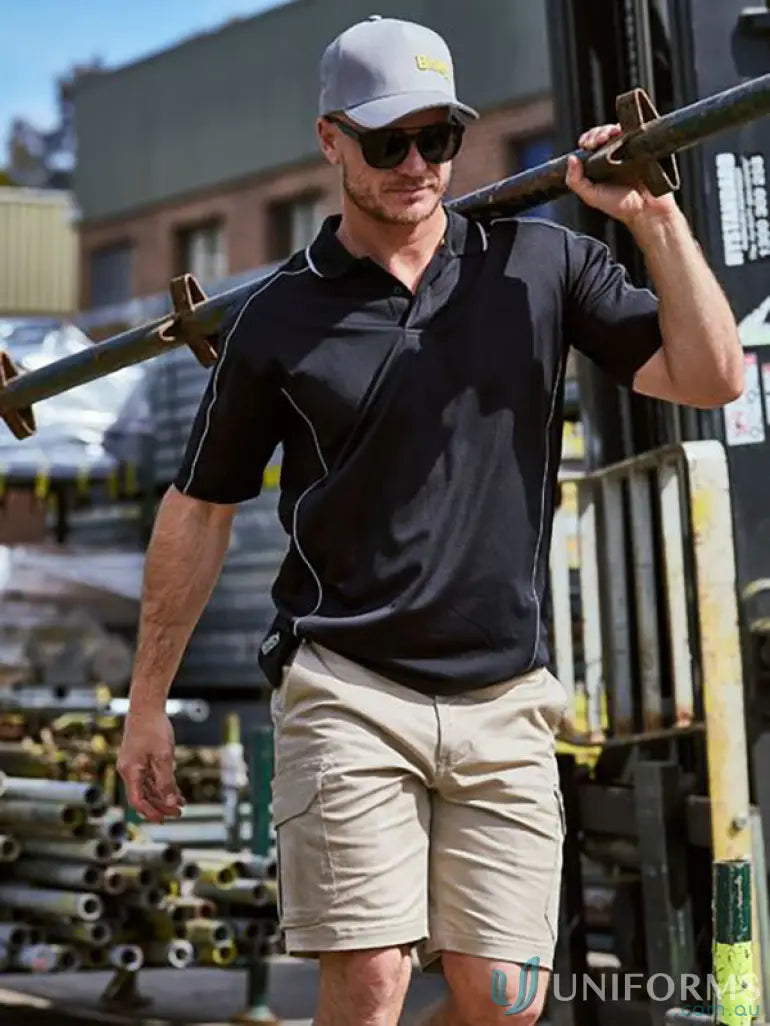 Man in cool mesh polo with reflective piping carrying a metal beam outside