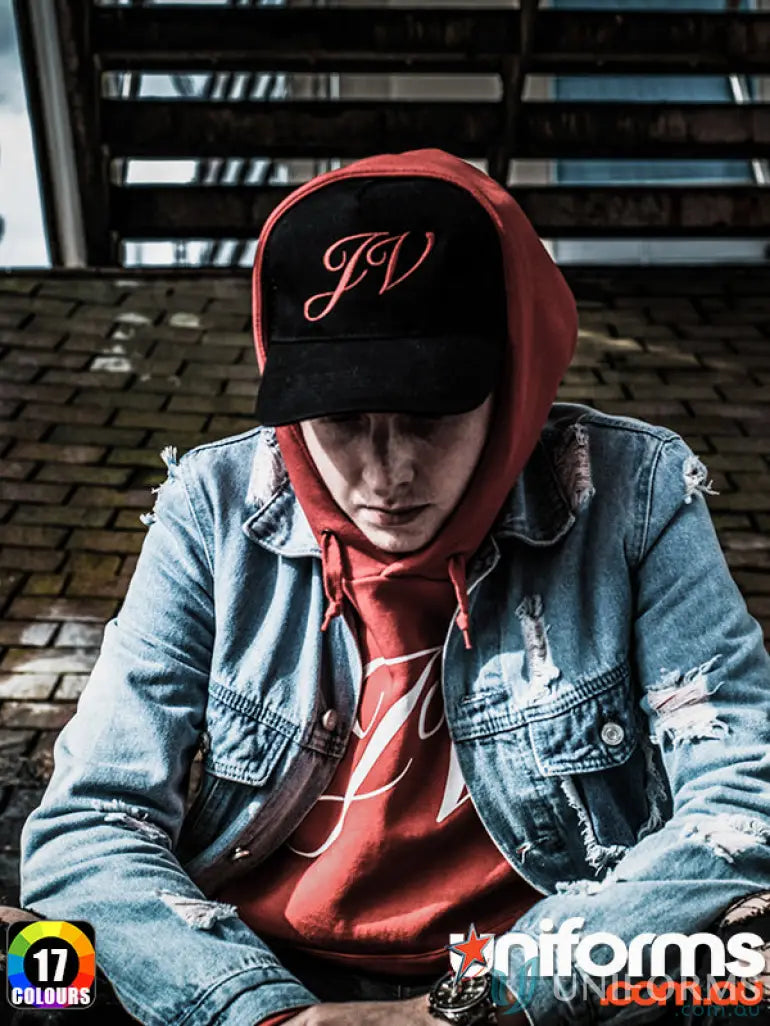 Person in red hoodie denim jacket and black cap from MOQ250 Embroidered Caps made with heavy brushed cotton