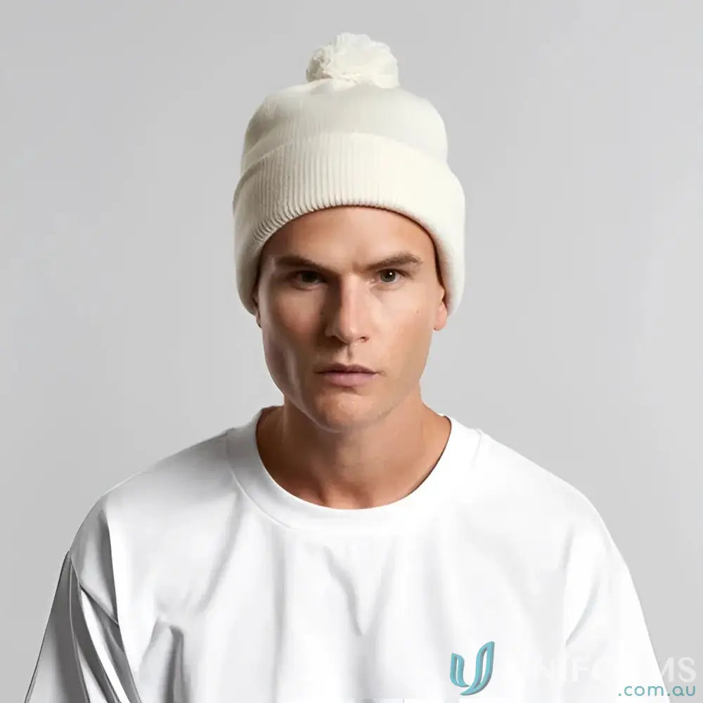 Light-colored recycled acrylic pom pom beanie with a cozy pom pom on top