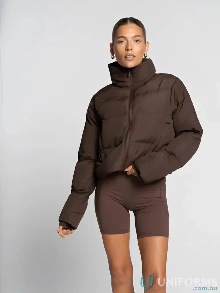 A sleek chocolate brown short puffer roast jacket with high collar and zipper perfect for work uniforms and workwear
