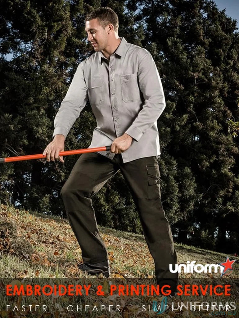 Man wearing Syzmik mens lightweight tradie long sleeve cotton twill shirt in work mode