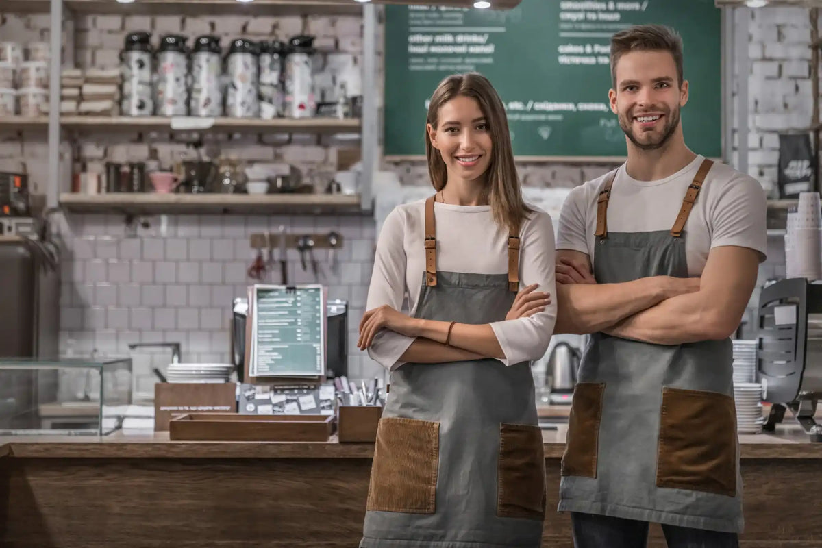 Denim apron with brown trim avoids uniform strategy mistakes venues make