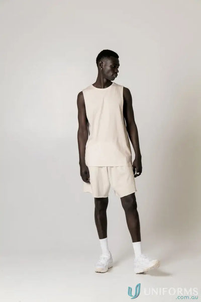 Man in beige Cotton Tank Top with raw cut sleeve and nameless chest embroidery