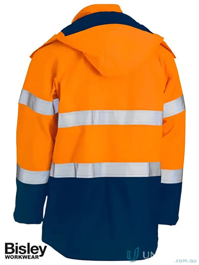 Orange and navy blue flame resistant workwear jacket with touch tape closure for hazardous environments