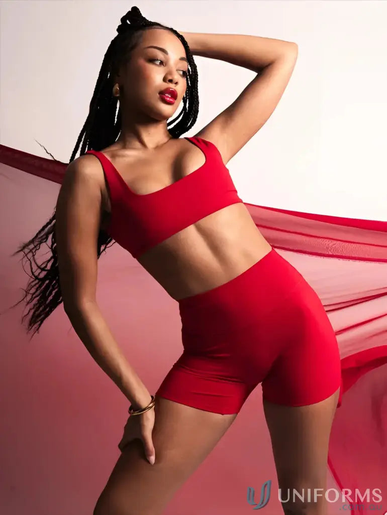 Red two-piece athletic set with cropped top and high-waisted scrunch cherry shorts made from stretchy workwear material