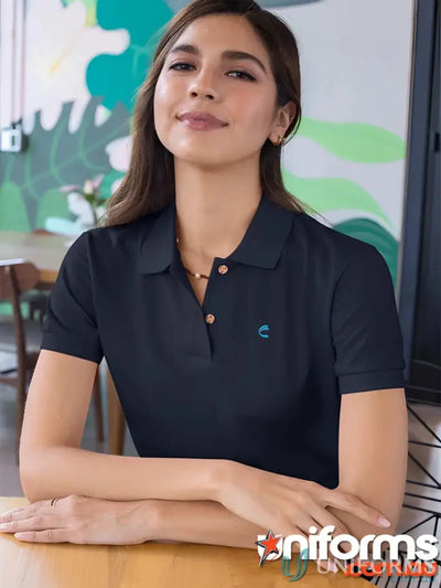 Women wearing IOP EMB Ladies Polo in modern fit uniforms with blue logo and buttons