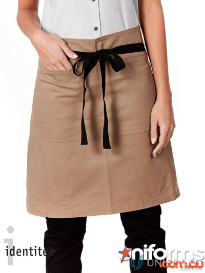 Jimmy Canvas Waist Apron in beige with front pockets, black tie, and brass rivets