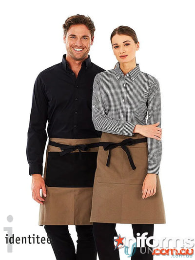 Two models wearing Jimmy Canvas Waist aprons with sage green cotton canvas and brass rivets