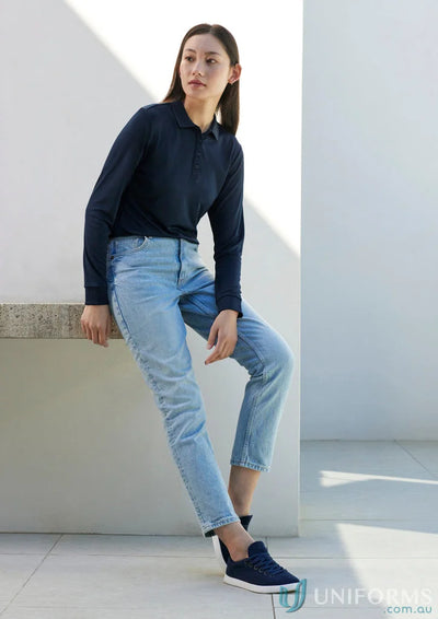 Woman in casual clothes wearing Ladies Action LS Polo made from breathable sports knit p206ll
