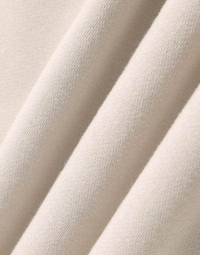 Premium oversized bone hoodie made of soft cream-colored cotton fabric with subtle woven texture for work uniforms