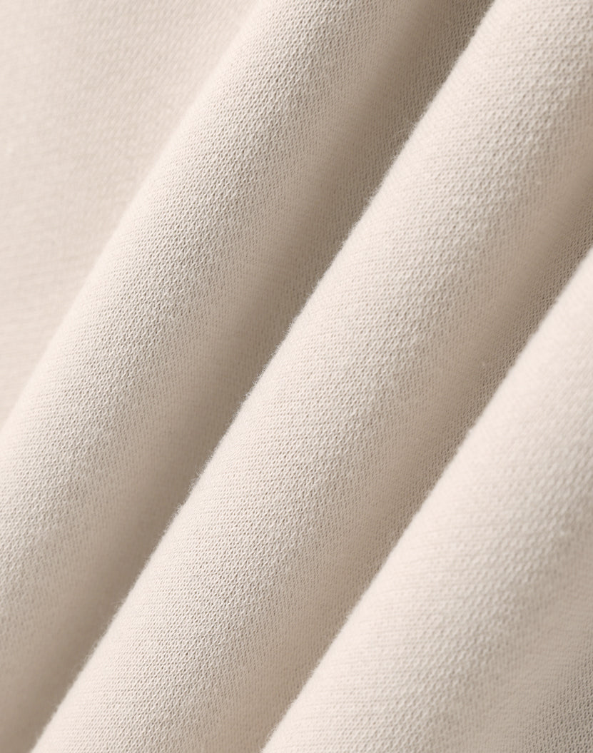 Premium oversized bone hoodie made of soft cream-colored cotton fabric with subtle woven texture for work uniforms