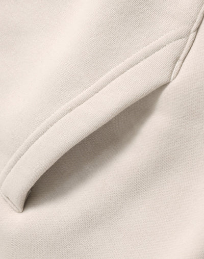Cream-colored oversized bone hoodie with soft textured fabric and neat seams ideal for workwear and uniforms