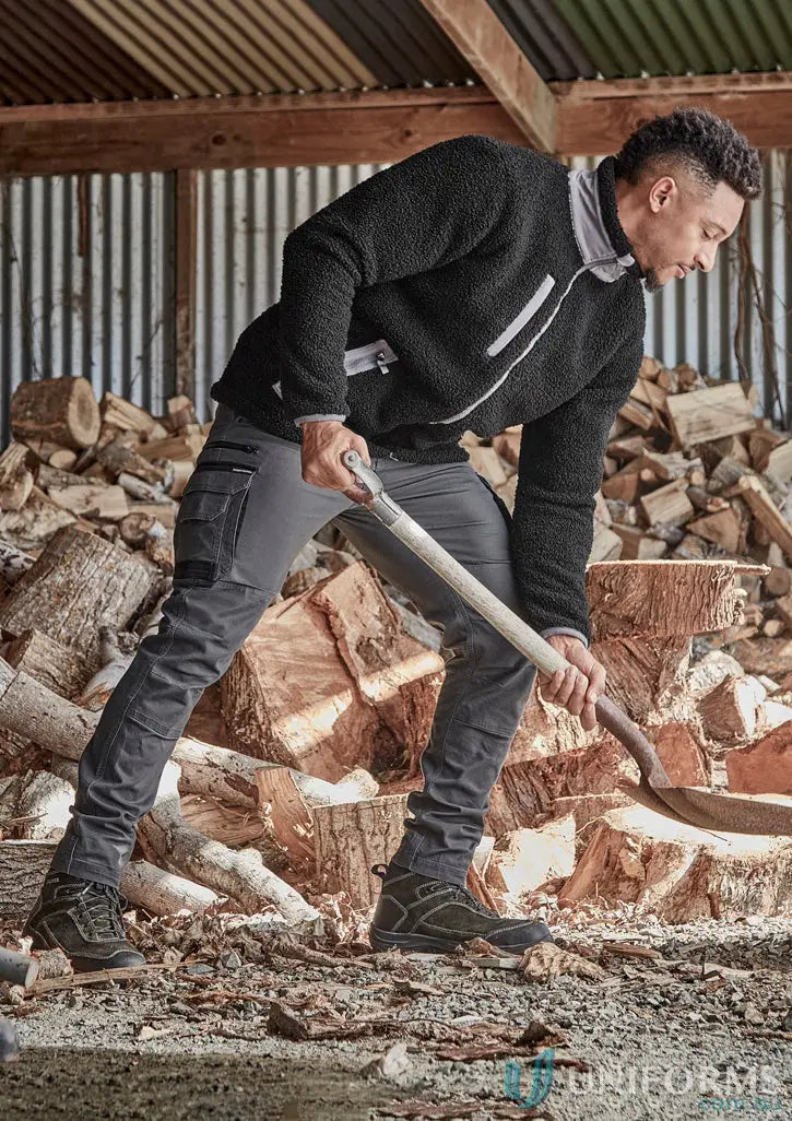 Man in streetworx heritage pant zp820 using shovel, showing functional pants solve durability