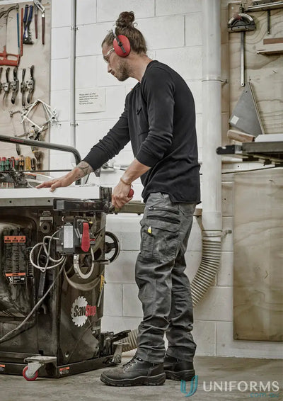 Man in safety gear wearing Syzmic Streetworx Heritage Pant ZP820 operating a table saw