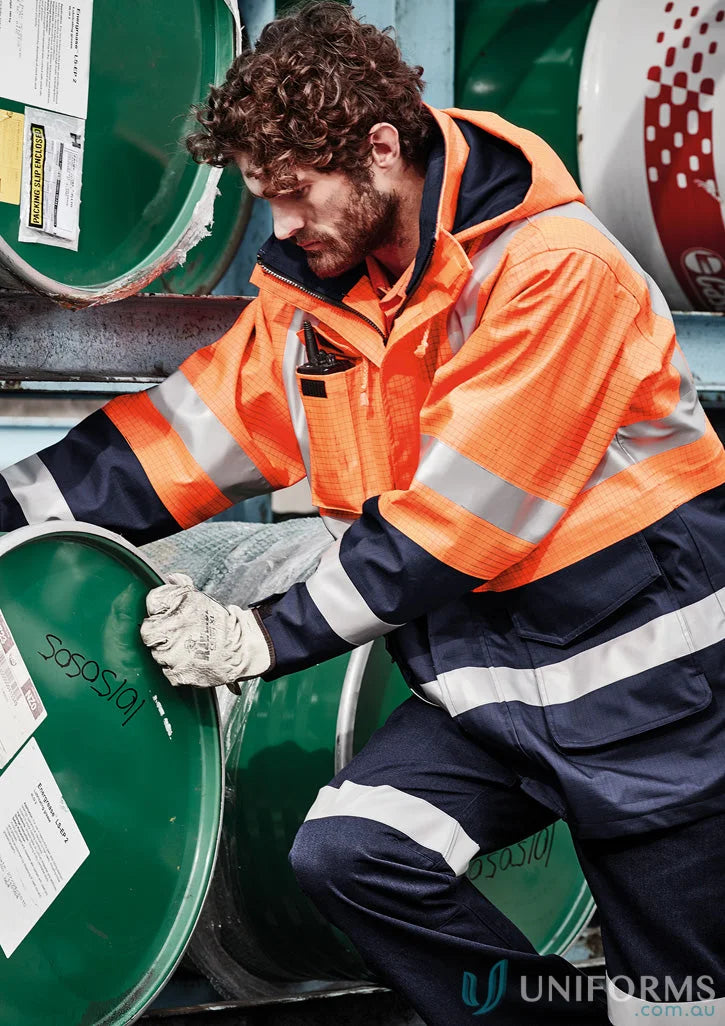 Man wearing Syzmik ZJ900 waterproof jacket, mens orange flame arc rated antistatic gear